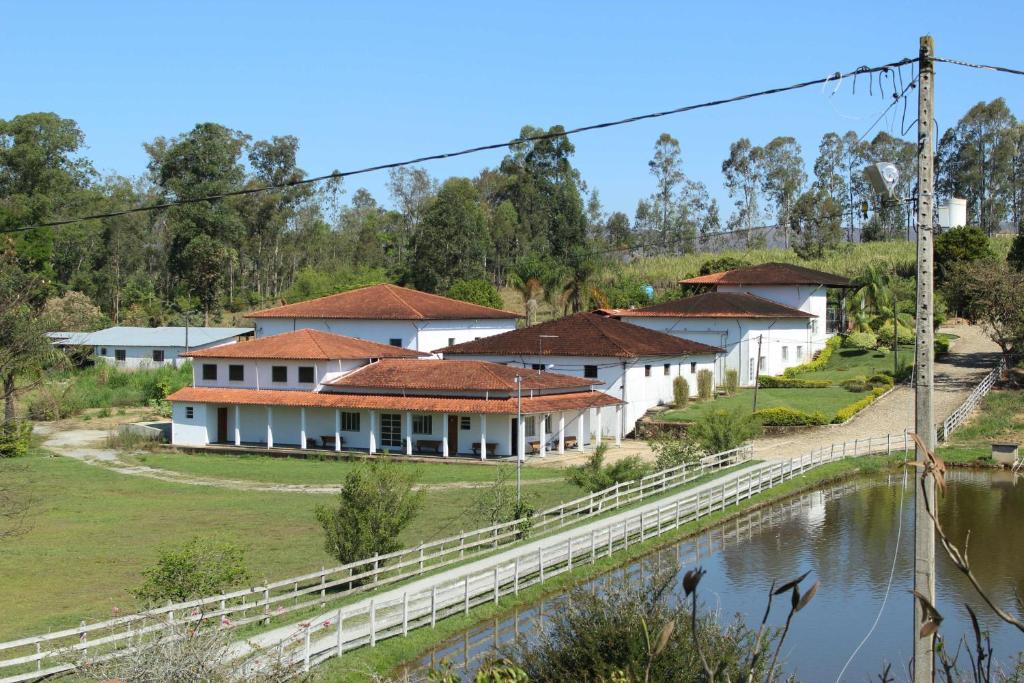 a row of houses next to a river at Hotel Fazenda Bela Vista in César de Pina