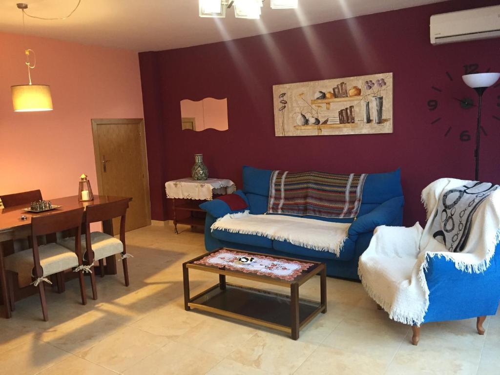 a living room with a blue couch and a table at Casa Vega in Sobradiel