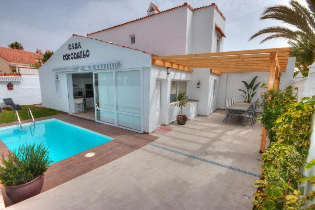 a villa with a swimming pool in a yard at Casa Cocodrilo in Playa del Ingles