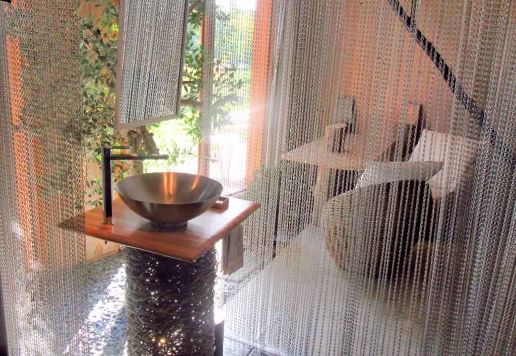 a bathroom with a bowl on a table next to a window at D'une Autre Nature in Mesland