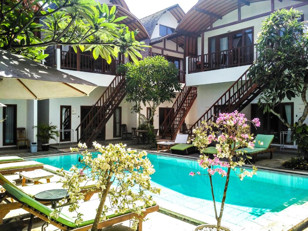 a resort with a swimming pool and a building at Naturela in Uluwatu