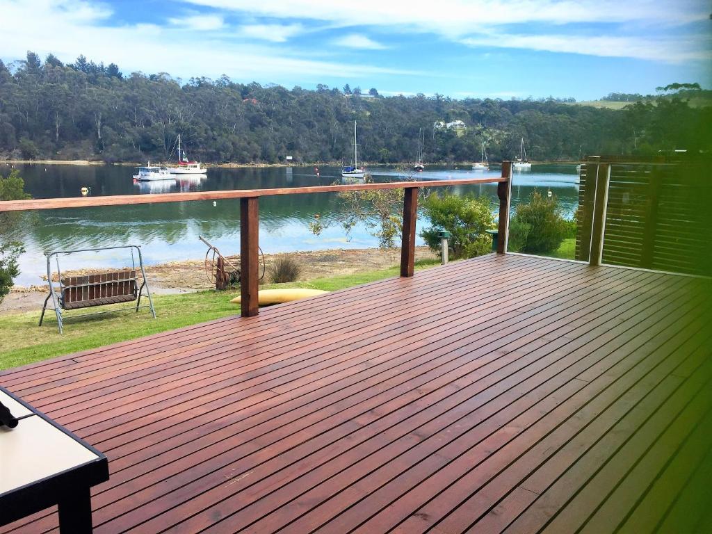 a wooden deck with a view of the water at A Slice of Paradise in Barnes Bay