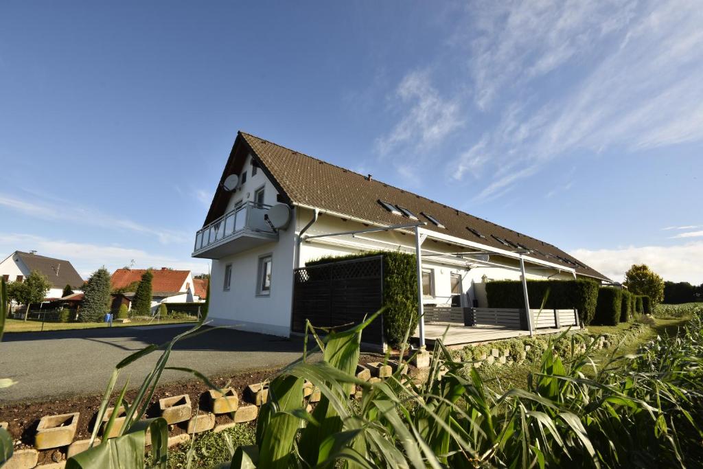 un petit bâtiment blanc avec un toit dans l'établissement Ferienwohnung Loipersdorf, à Loipersdorf bei Fürstenfeld