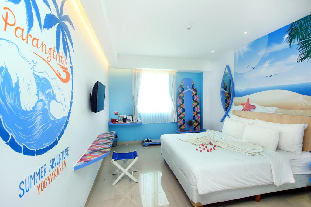 a bedroom with a surfboard mural on the wall at Uniq Hotel in Yogyakarta