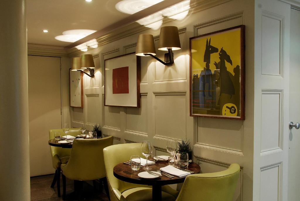 a dining room with two tables and yellow chairs at Montcalm Brewery, London City in London