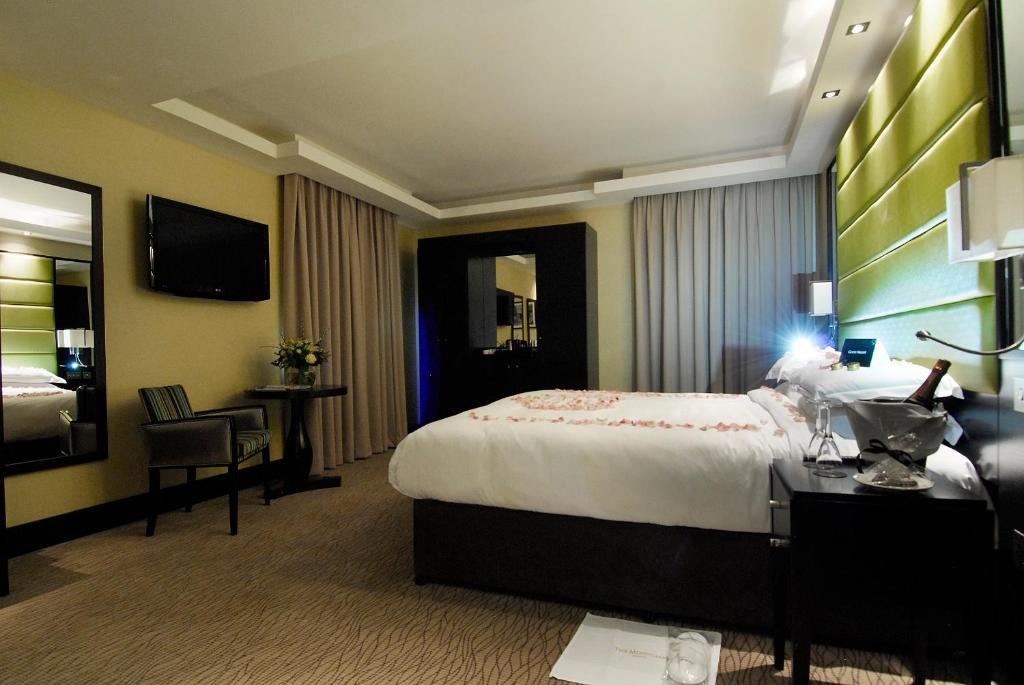 a hotel room with a large bed and a desk at Montcalm Brewery, London City in London