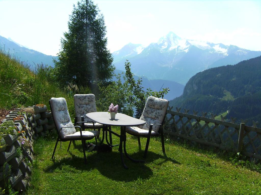 a table and two chairs with a view of mountains at Ferienwohnung Daum in Hippach