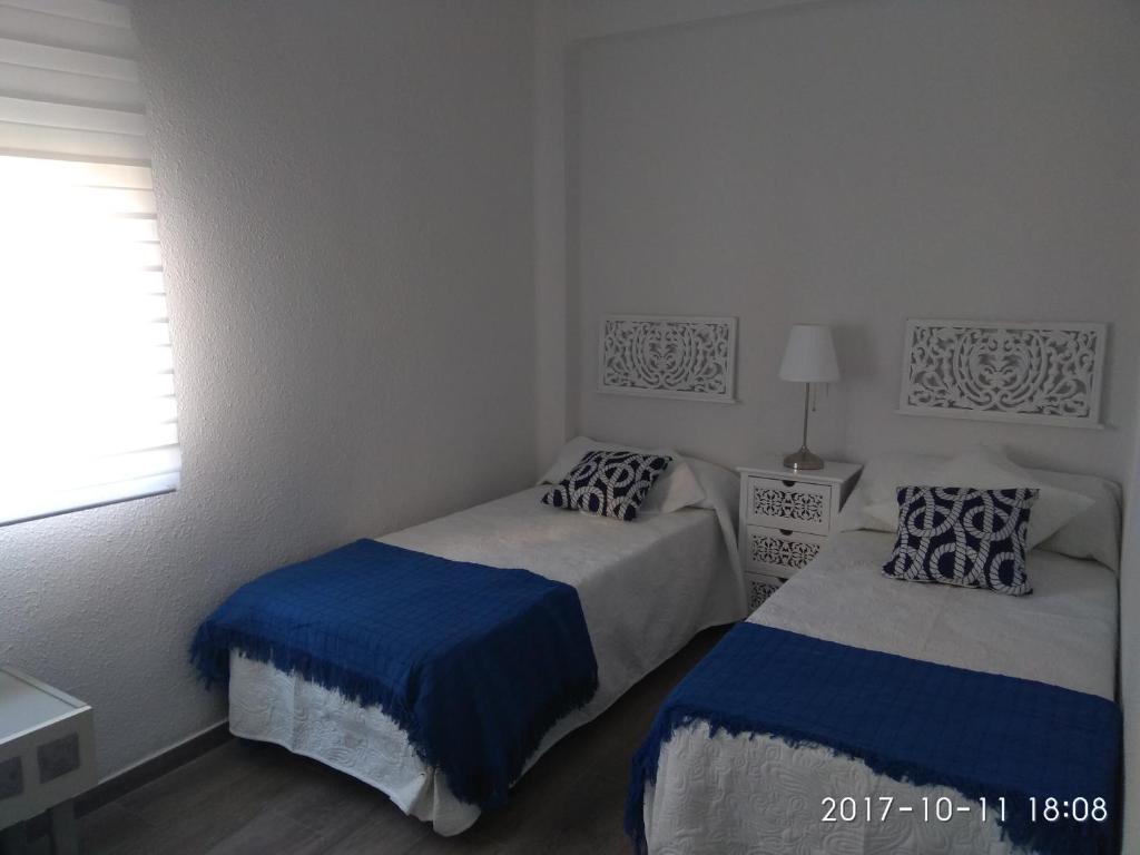 A bed or beds in a room at Piso Vacacional