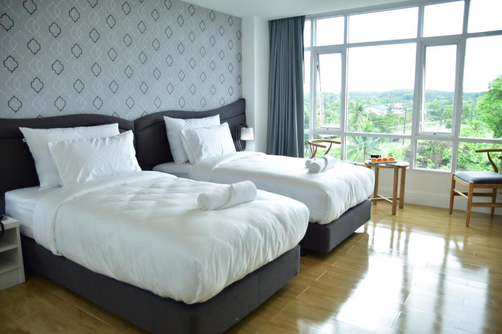Postel nebo postele na pokoji v ubytování Avada Hotel