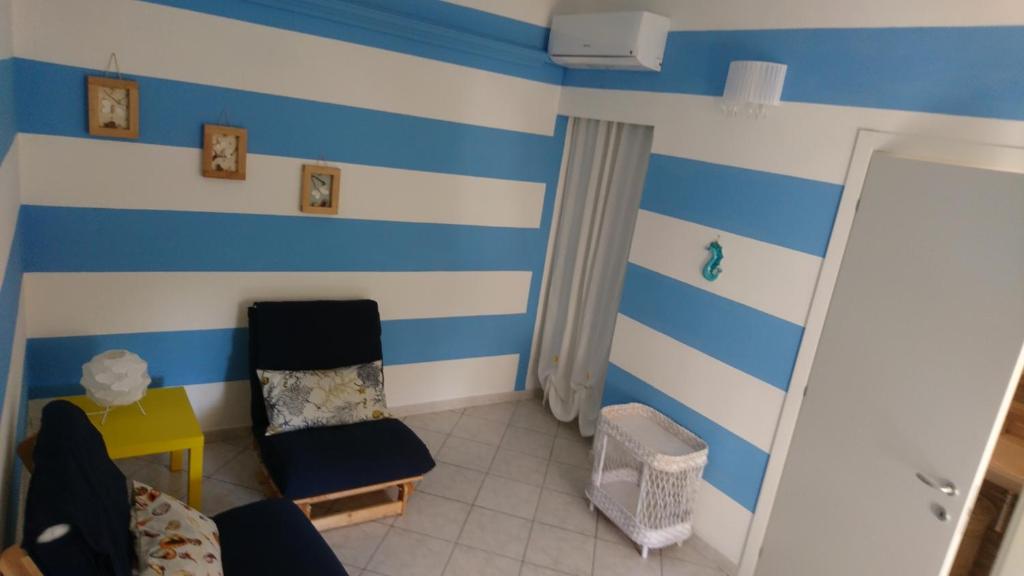 a room with blue and white stripes on the wall at La Divina in Muggiano