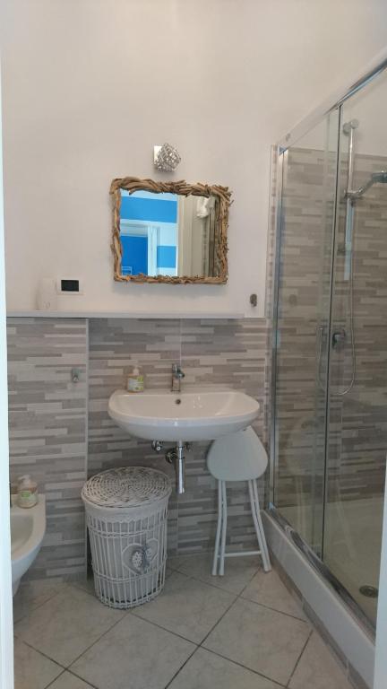 a bathroom with a sink and a shower at La Divina in Muggiano