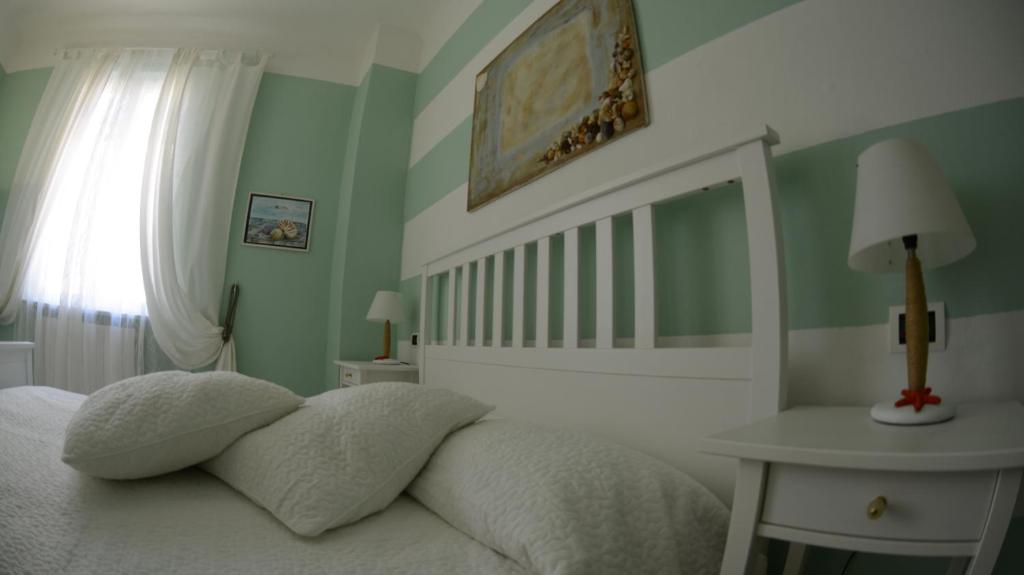 a bedroom with a bed and a table and a window at La Divina in Muggiano
