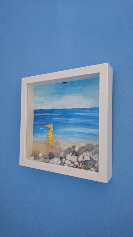 a picture of a painting of a dog on the beach at La Divina in Muggiano