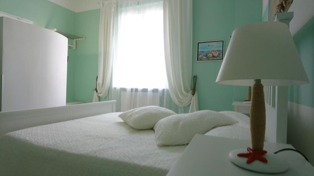 a bedroom with a bed with a lamp on a table at La Divina in Muggiano