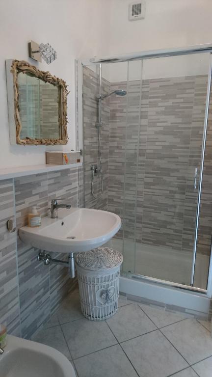 a bathroom with a sink and a shower at La Divina in Muggiano