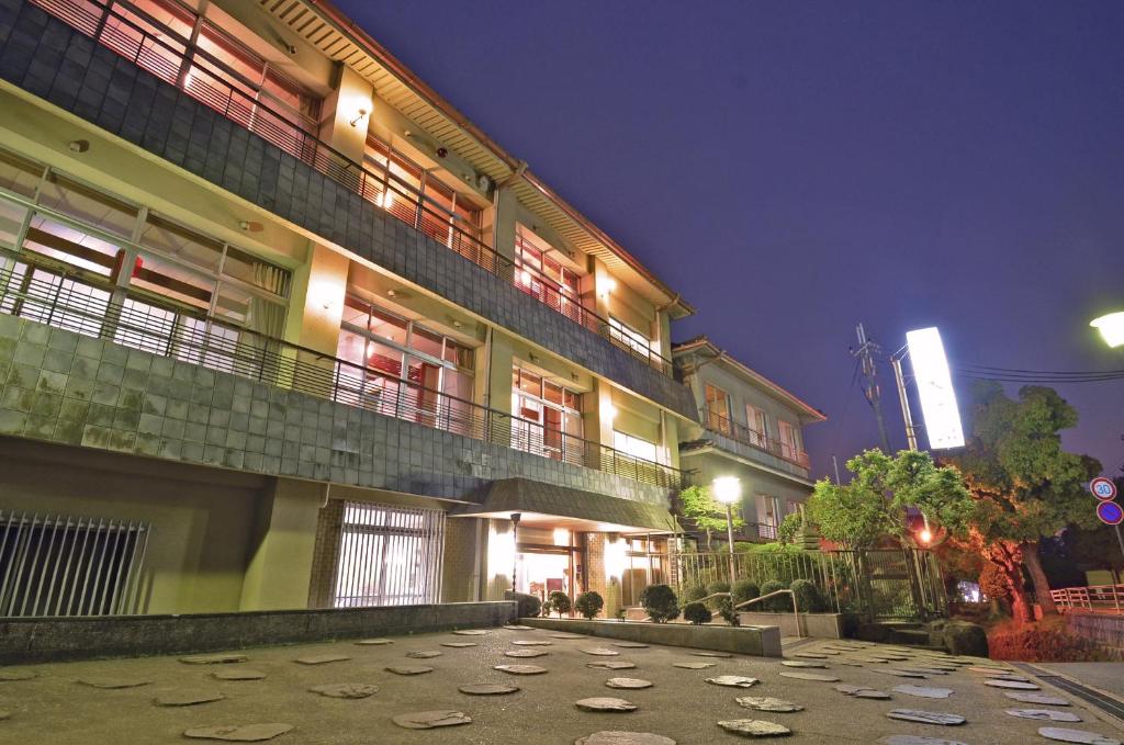 a large building with a walkway in front of it at night at Daibutsukan in Nara