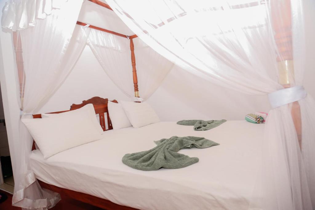 Postel nebo postele na pokoji v ubytování Tithira Guest House