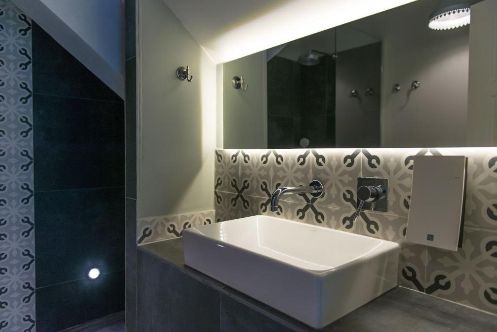 a bathroom with a white sink and a mirror at Smokvica Dorćol B&B in Belgrade