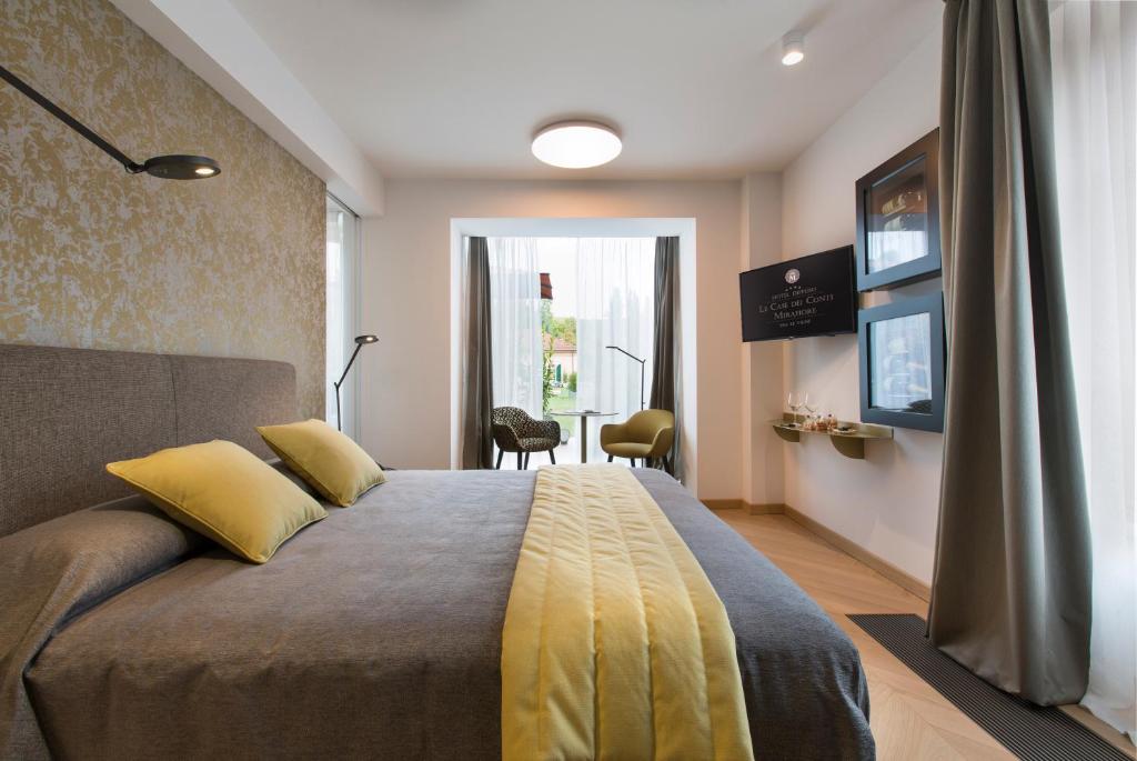 Кровать или кровати в номере Villaggio Narrante - Le Case dei Conti Mirafiore