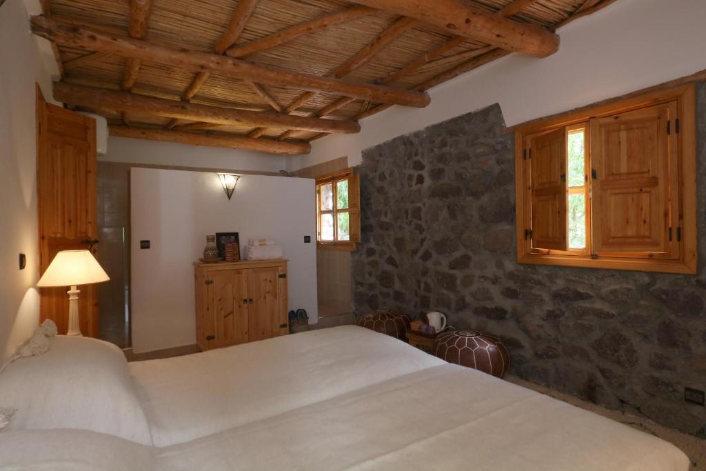 Postel nebo postele na pokoji v ubytování Hiba Lodge