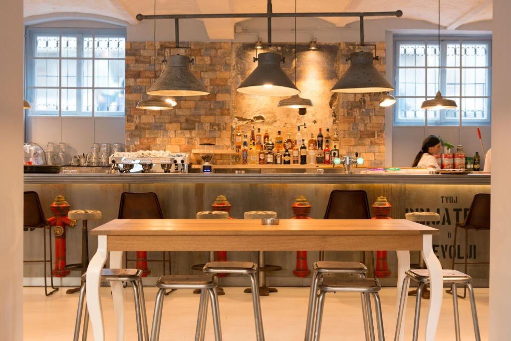 a bar with a wooden table and chairs at Smokvica Dorćol B&B in Belgrade