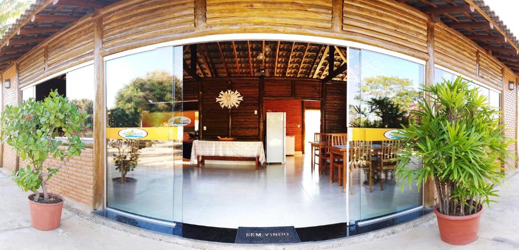 a building with a large glass doorway with a dining room at Vila Mantilla Pousada in Três Marias