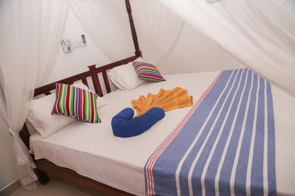 Postel nebo postele na pokoji v ubytování Tithira Guest House