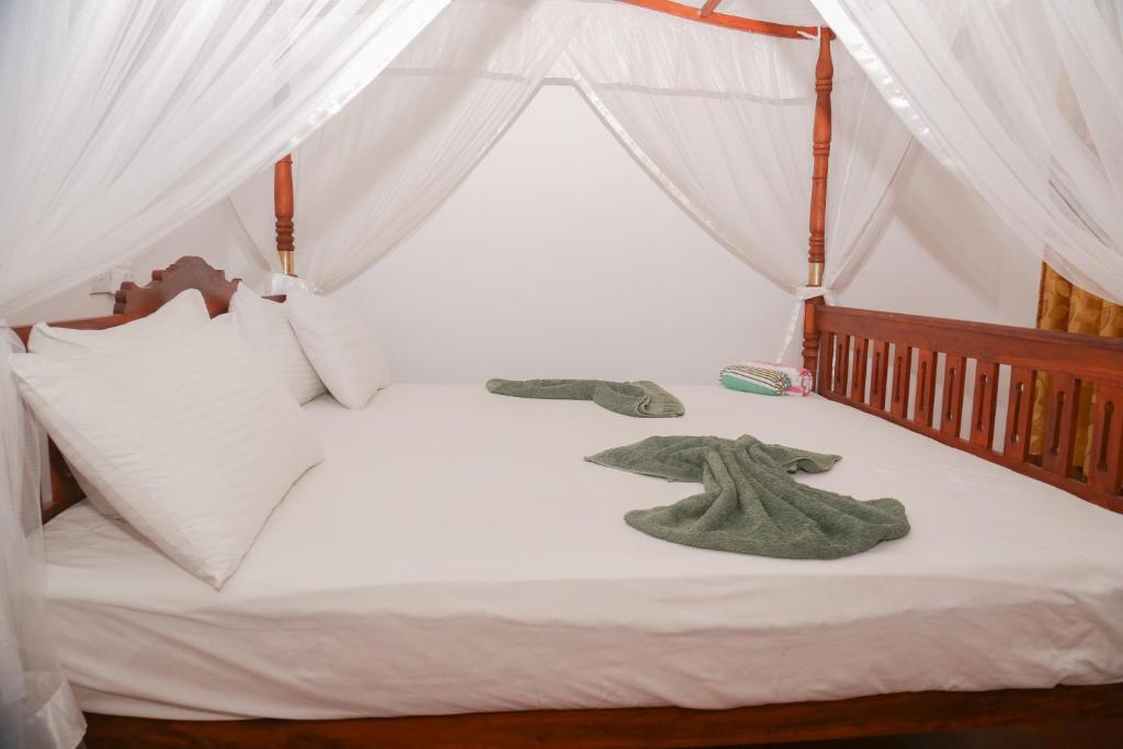 Postel nebo postele na pokoji v ubytování Tithira Guest House