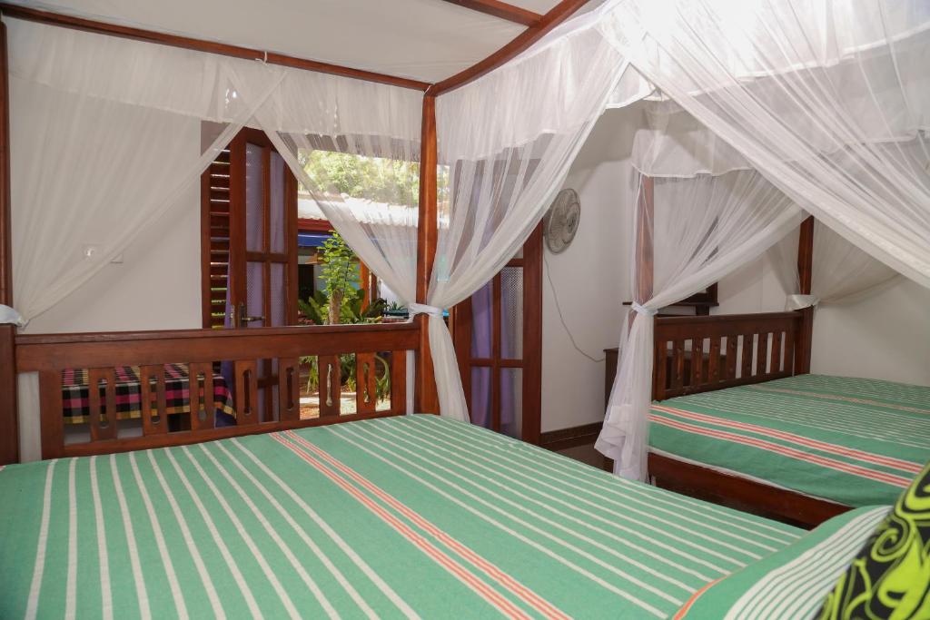Postel nebo postele na pokoji v ubytování Tithira Guest House