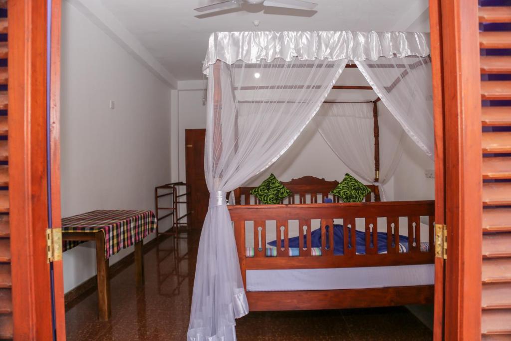 Postel nebo postele na pokoji v ubytování Tithira Guest House