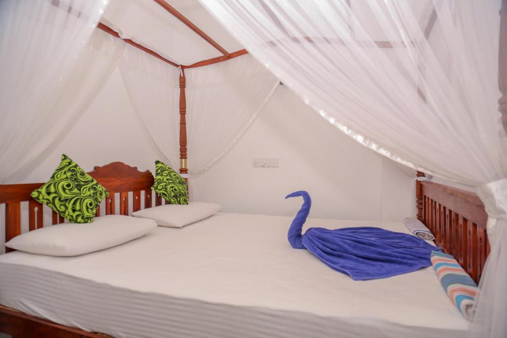 Postel nebo postele na pokoji v ubytování Tithira Guest House