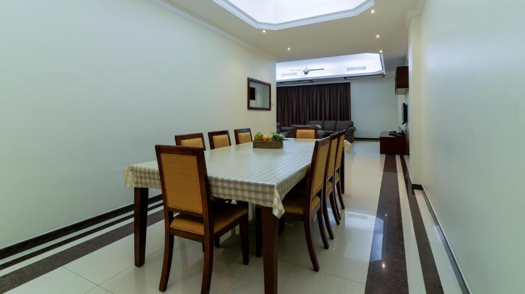 a dining room table and chairs in a room at Tanzanite Executive Suites in Dar es Salaam