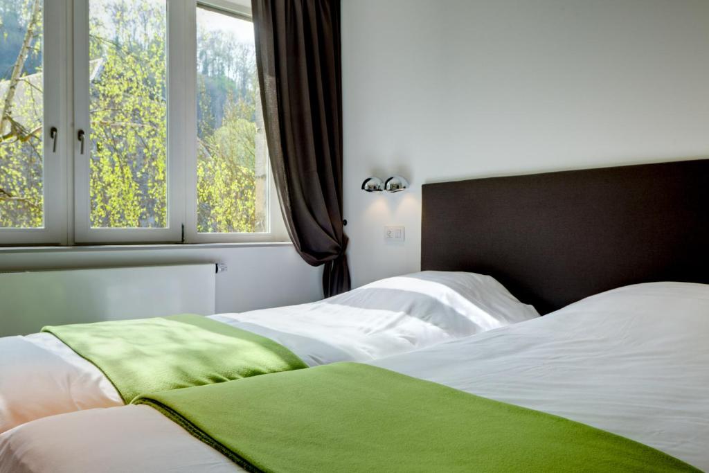 Postel nebo postele na pokoji v ubytování Hotel Le Clos des Récollets