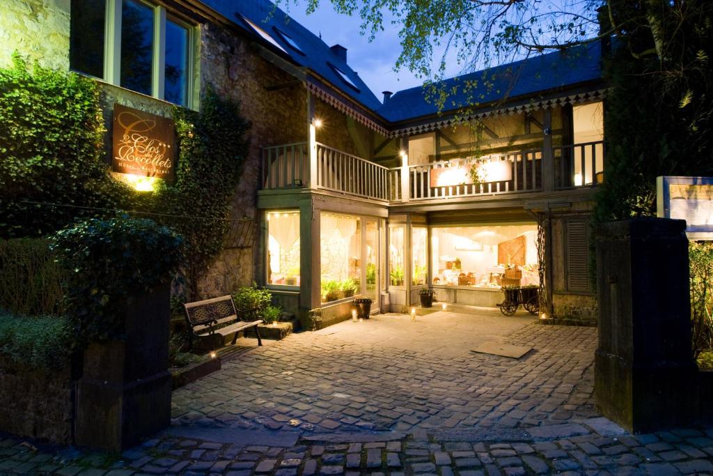 a large house with a patio at night at Hotel Le Clos des Récollets in Durbuy