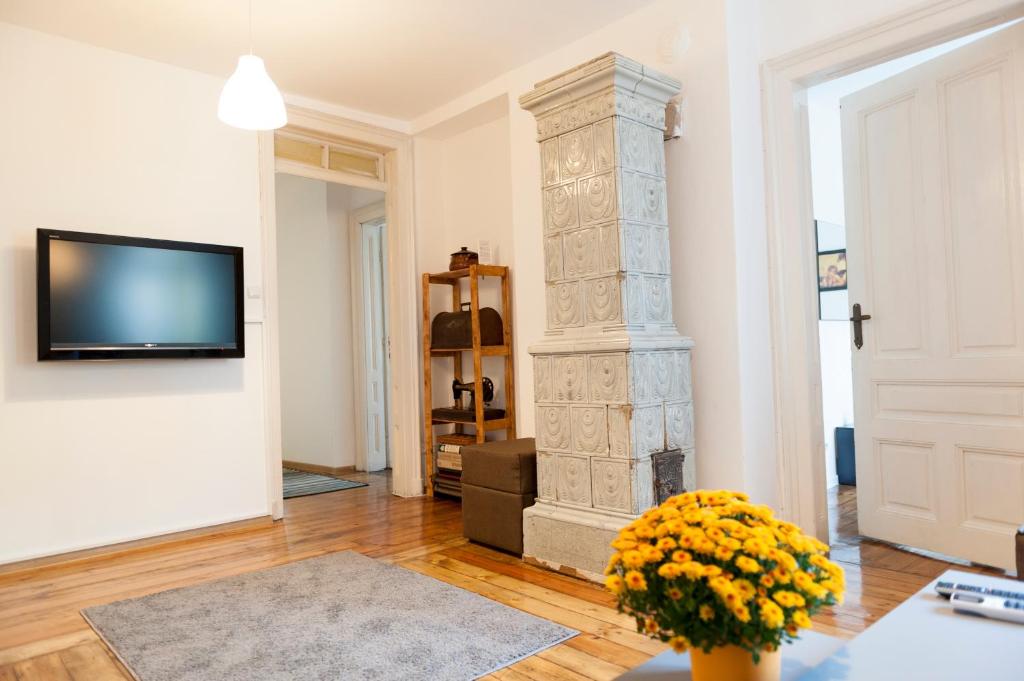 a living room with a stone pillar and a tv at Graf Ignatiev - 3BR APART in Sofia