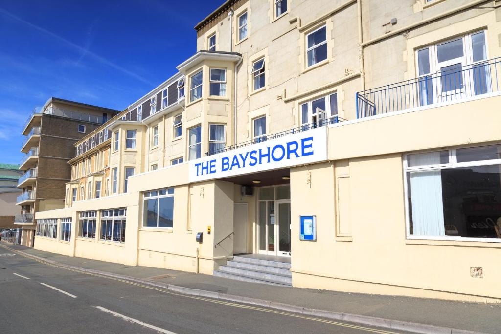 a building with a sign on the side of it at Bayshore Hotel in Sandown