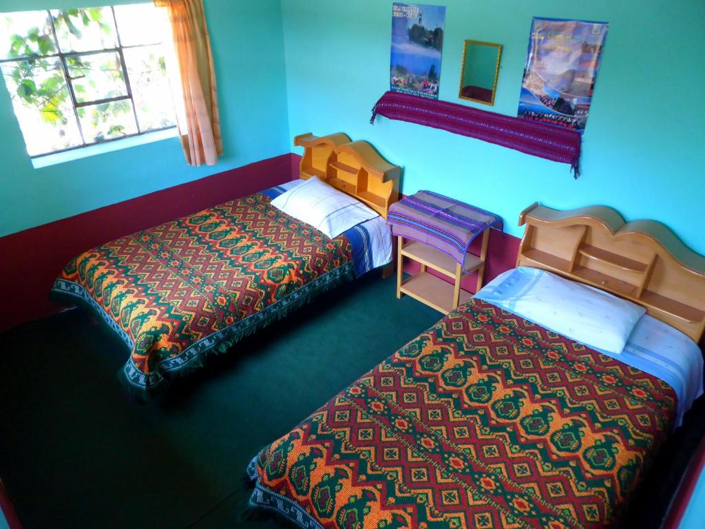 Ліжко або ліжка в номері Taquile Familia Celso