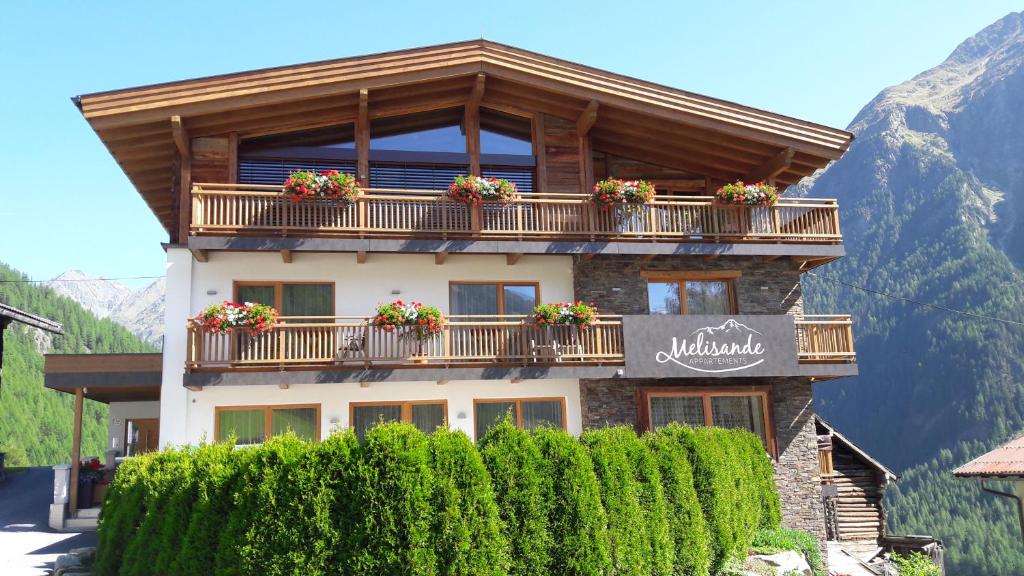 a building with a balcony with flowers on it at Haus Melisande in Sölden
