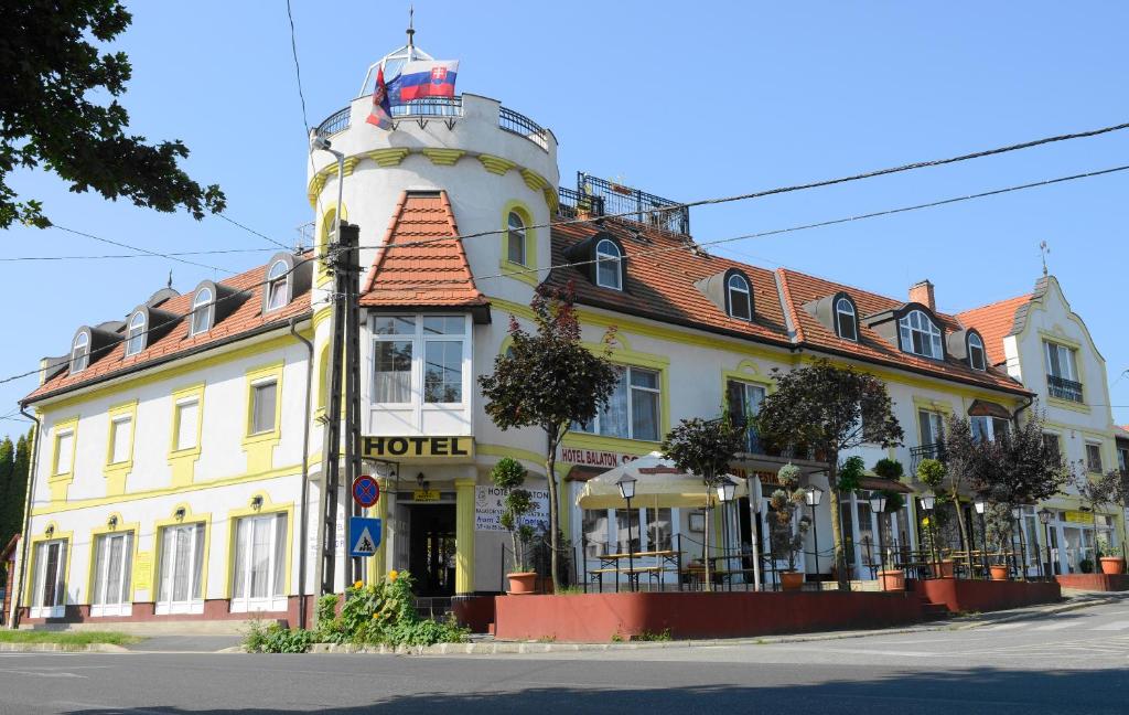 a building with a lighthouse on top of it at Hotel Balaton Fonyód in Fonyód