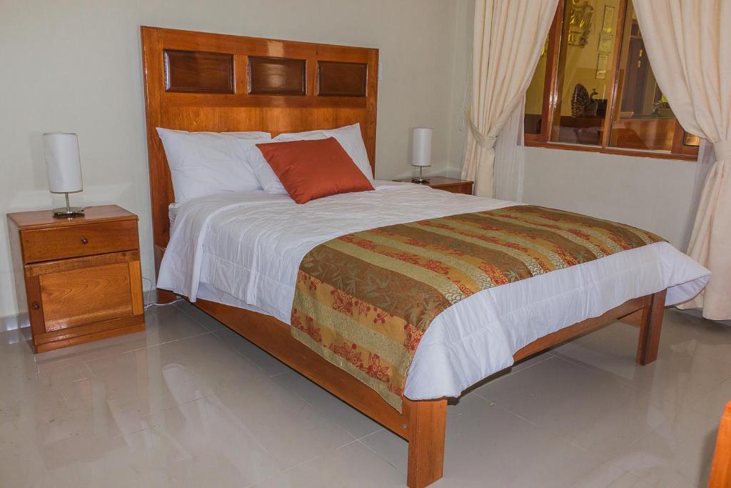 Postel nebo postele na pokoji v ubytování La Floresta Tarapoto Hostal