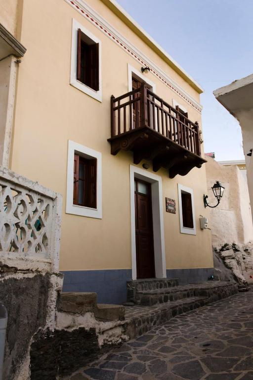 a building with a balcony on the side of it at Irene's House in Olympos