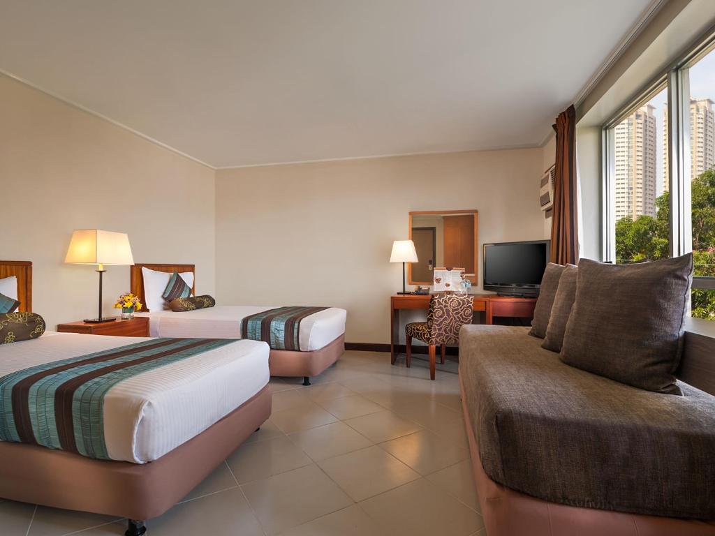 Postel nebo postele na pokoji v ubytování Hotel Kimberly Manila