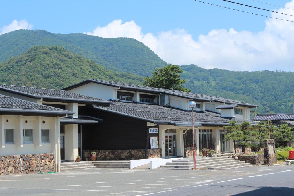 a row of houses with mountains in the background at Tango Onsen Hashiudosou in Kyotango