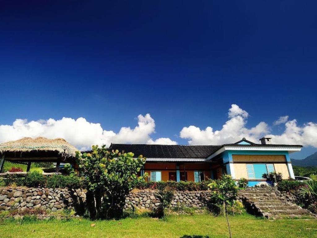 a house with a stone wall in front of it at Wan-Lu-Yi in Changbin