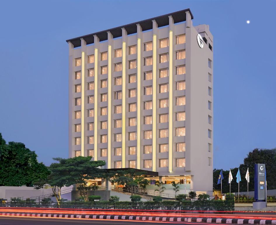 a building with a clock on the side of it at Fortune Inn Promenade, Vadodara - Member ITC's Hotel Group in Vadodara