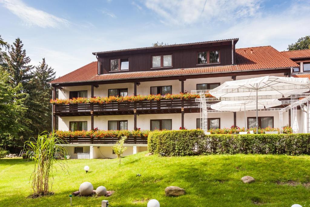 ein großes Gebäude mit Rasen davor in der Unterkunft Hotel Forsthaus in Berlin