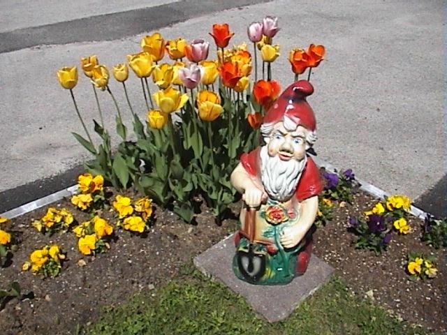 a statue of a santa on a motorcycle next to flowers at Haus Waldfriede in Pertisau