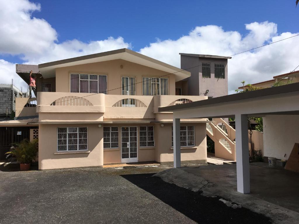 a large house with a driveway in front of it at BR Apartment & Studios in Curepipe