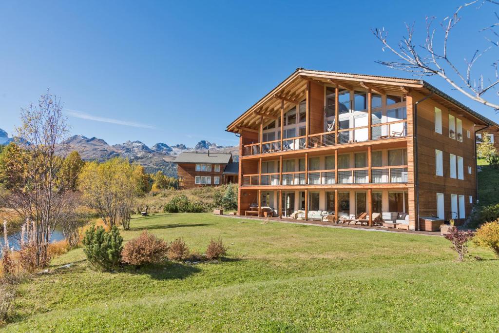 a large house on a hill with a yard at Chesa Rivarel - Pontresina in Pontresina