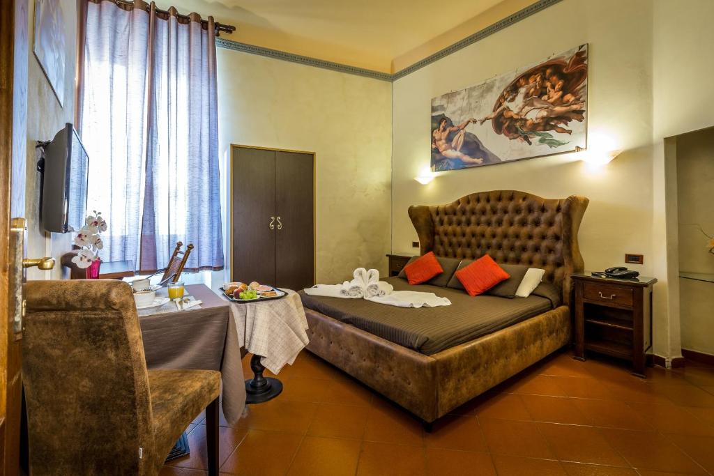 a hotel room with a bed and a table with a table at B&B Hotel Delle Tele in Florence